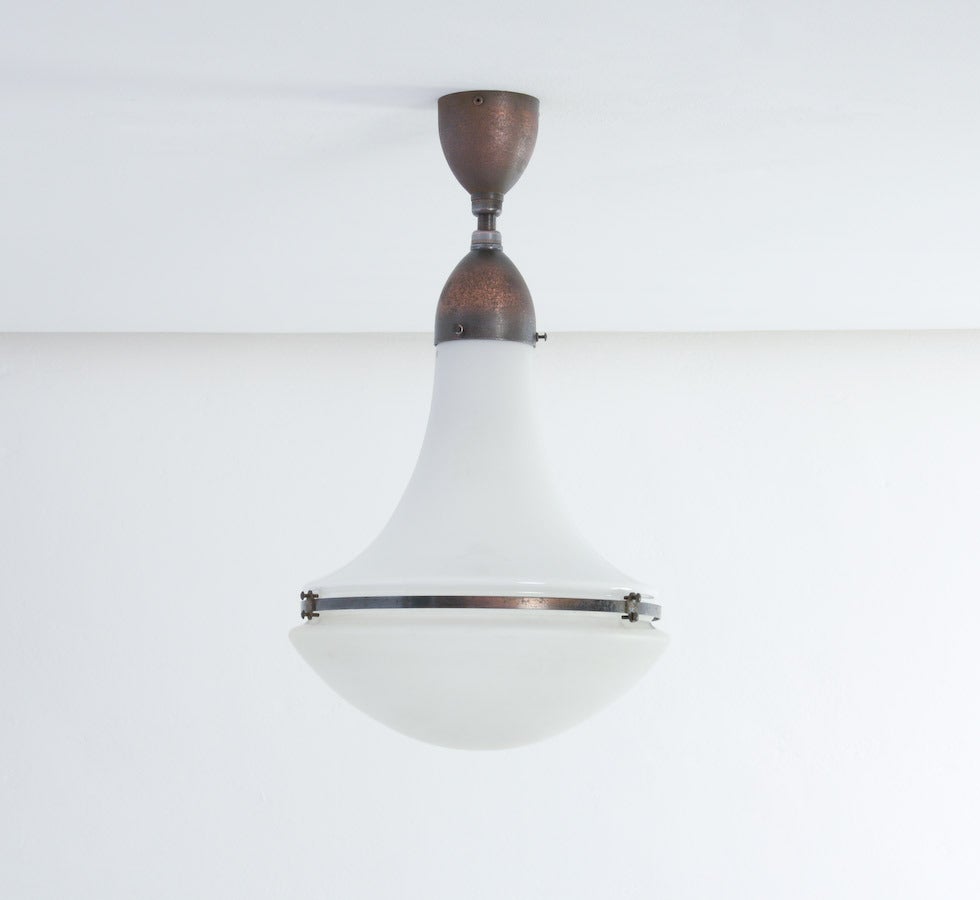 The Luzette hanging lamp was designed by Peter Behrens in 1908 for Siemens.
This lamp is complete original with a nice combination of a opaline glass upper shade and an frosted glass lower shade. The glass shades are numbered and marked with the