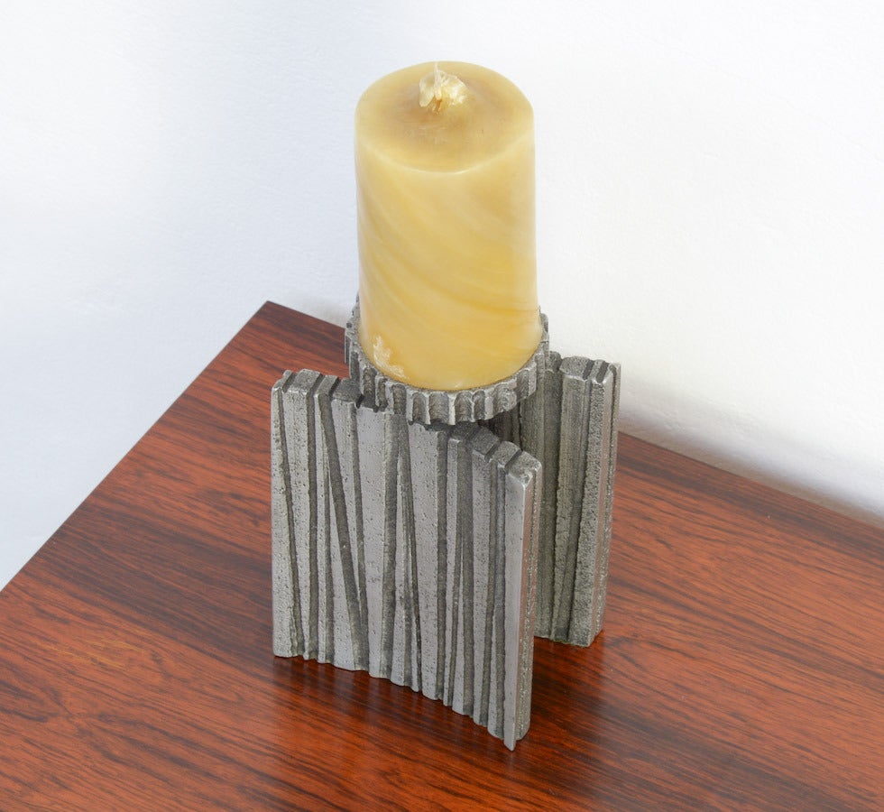 This candle holder was created by Willy Ceysens (1929-2007) in the 1960s.
Willy Ceysens was a Belgian artist who created abstract aluminium sculptures and design objects in the 1960s. Later he became jeweler and silversmith.
This brutalist candle