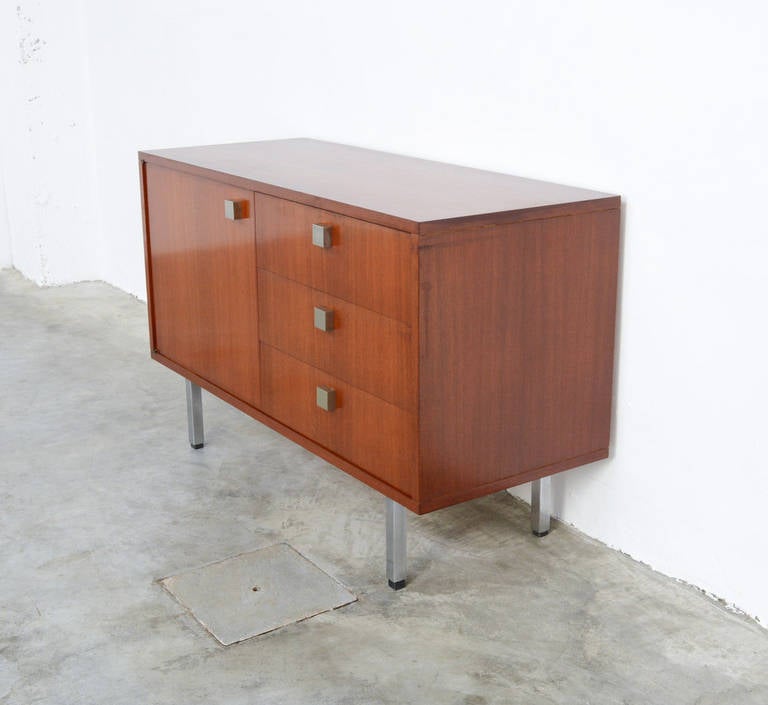 This cabinet is designed by Alfred Hendrickx for Belform in the 1960s.
It is a nice piece of furniture made of teak veneer, with handels and feet in chromium-plated metal.
As all the furniture designed by Hendrickx and made by Belform, this