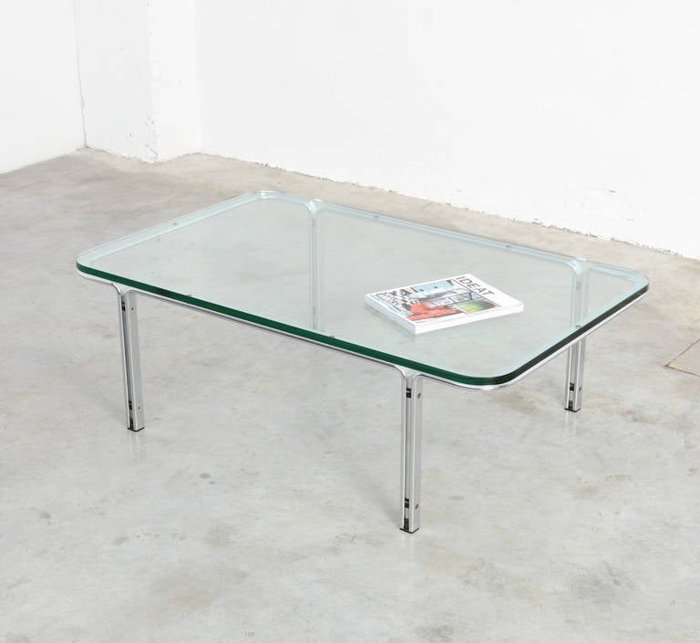 This high quality timeless coffee table is designed by Horst Bruening for Kill International, Germany around 1970.
It has a chromed steel base with a 2 cm thick original glass top. There is a little restoration on the glass top (see picture).
This
