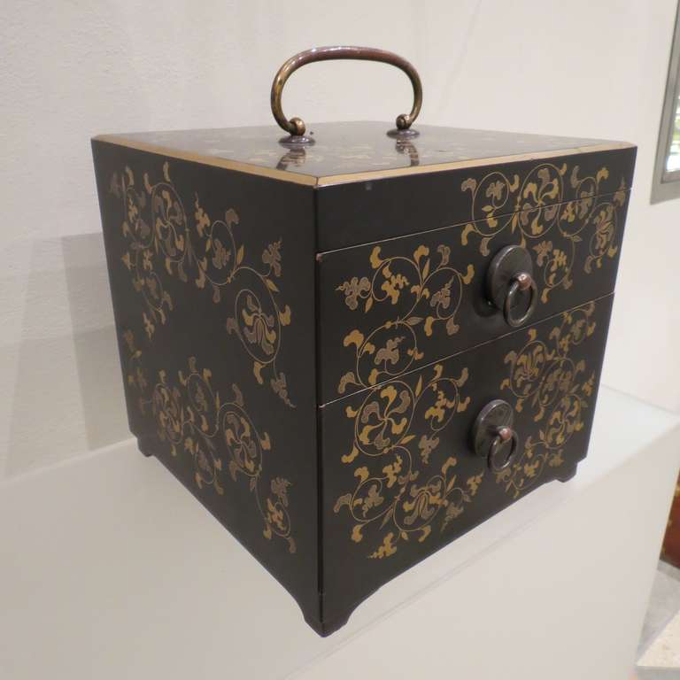 Two drawers jewelry box beautifully decorated on a black ground with overall gold flowering. Meiji period, circa 1900.