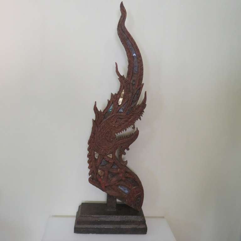 Used in Thailand as temple roof finials or in pairs at entrances to guard against evil spirits and natural disasters, the powerful, mystical naga are among the most revered Buddhist symbols. With its soaring curving form and large size, this