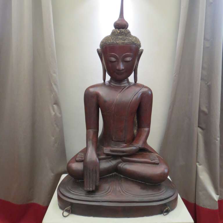 Exceptionally large Burmese dry lacquer statue of a Buddha on a raised pedestal base. The figure depicted seated in the attitude of 