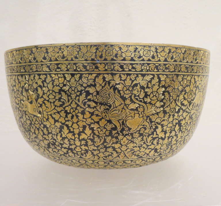 The designs on this gilded niello silver bowl are particularly fine and flowing. The sides and base are all decorated with repeated stylised orchid motifs and animals in niello work that has then been gilded (gold plated).

The niello technique is