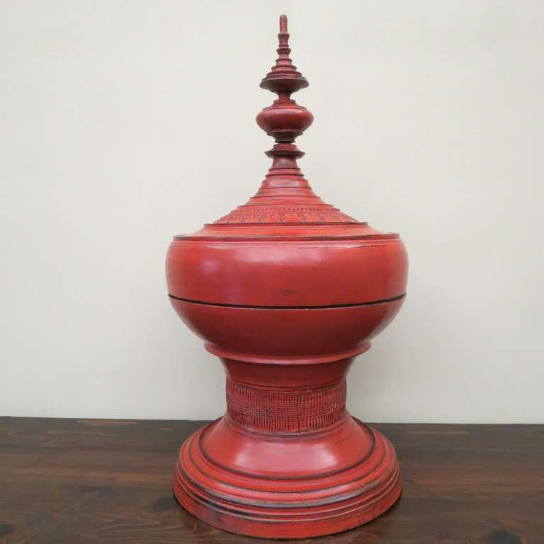 Late 19th century Burmese red lacquer special ceremonial offering vessel. Detailed spire form the top of the lid, stepped curved ring moulded bowl above round base. Multiple layers of red lacquer adorn this pagoda shaped ceremonial vessel. Used for