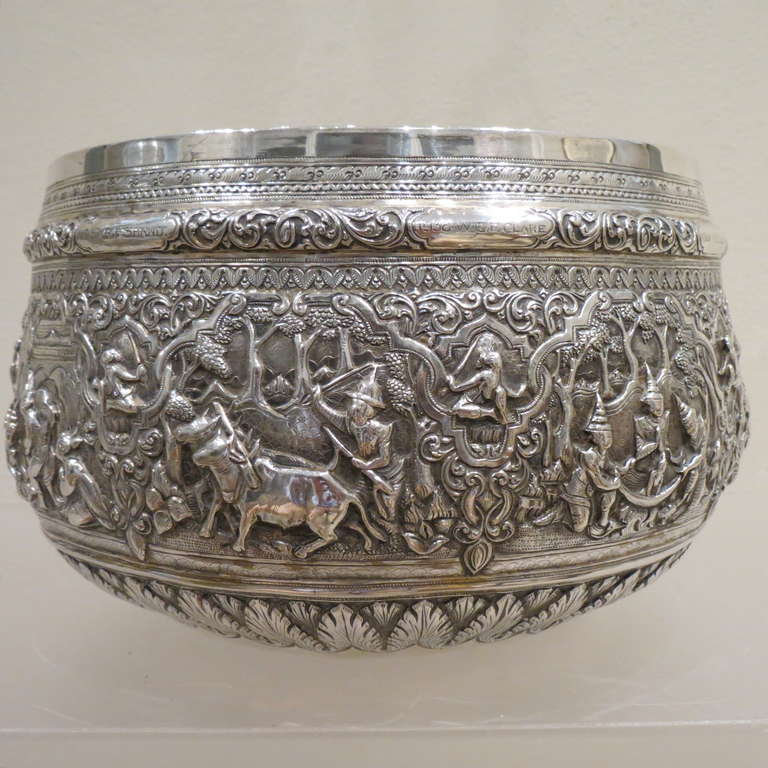 This fine, colonial Burmese bowl is repoussed with eight panels of scenes of multiple figures in Burmese dress, all in high relief.The scenes draw on a
Burmese legend.All the figures are in particularly precise, high relief. The scenes are