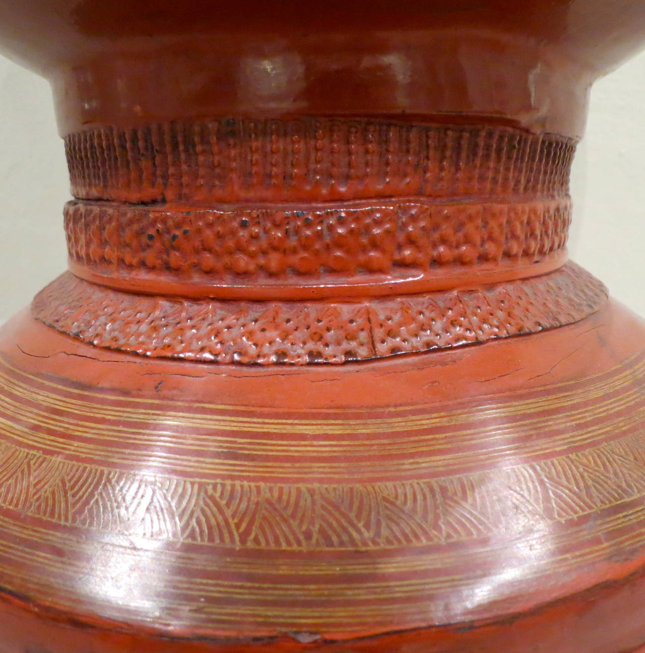 Late 19th century Burmese
red lacquer special
ceremonial offering vessel.
Detailed spire form the top of
the lid, stepped curved ring
molded bowl above round
base. Multiple layers of red
lacquer, densely decorated, adorn this
pagoda shaped