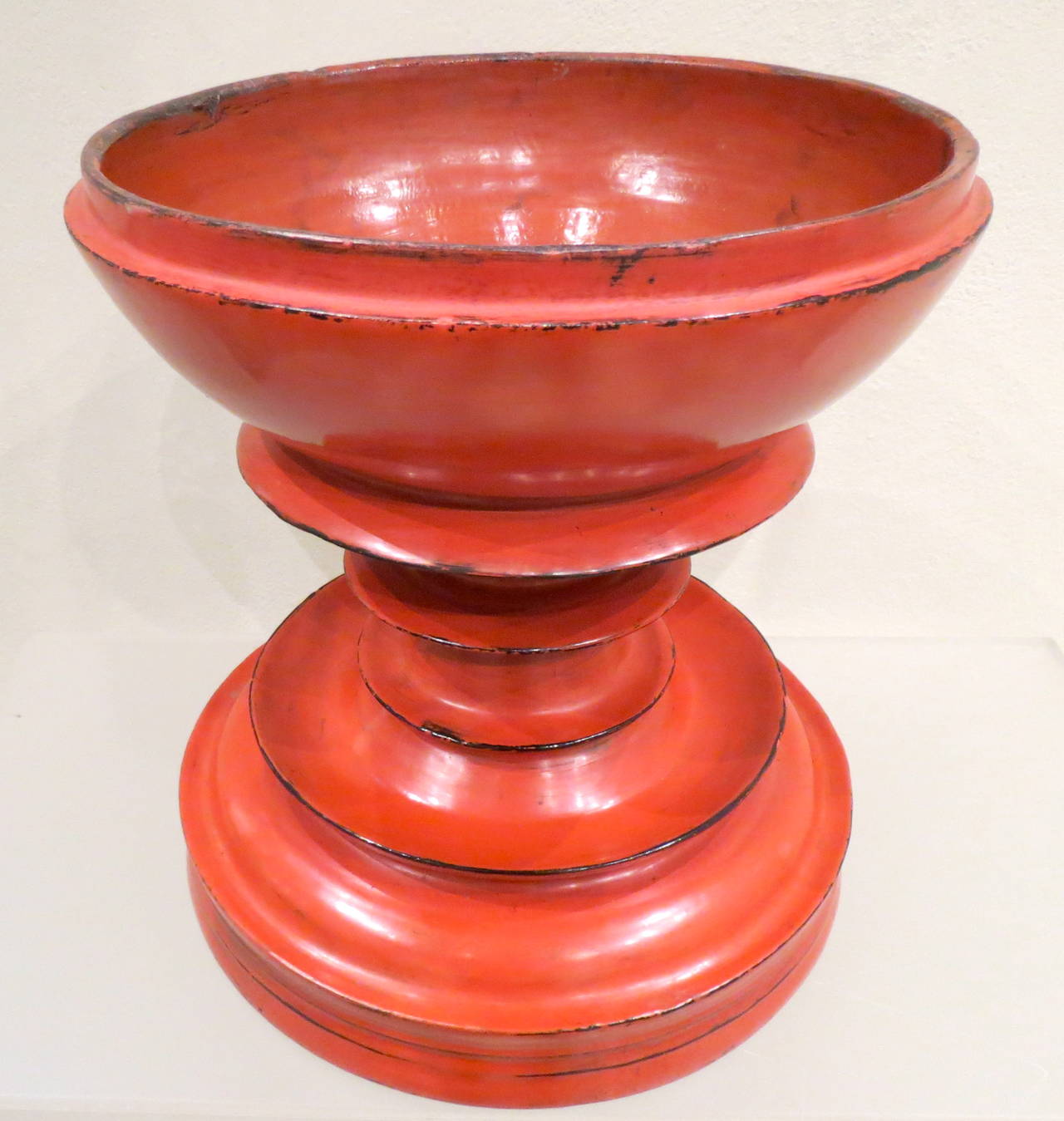 Late 19th century Burmese
red lacquer special
ceremonial offering vessel.
Detailed spire form the top of
the lid, stepped curved ring
molded bowl above round
base. Multiple layers of red
lacquer adorn this
pagoda shaped ceremonial
vessel.