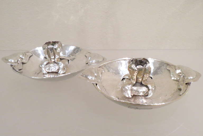 This pair of sterling silver art nouveau hand-crafted chambersticks probably were produced by the Duchess of Sutherland Guild around 1902 who gave  contribution to the Arts and Crafts Movement. No hallmarks.