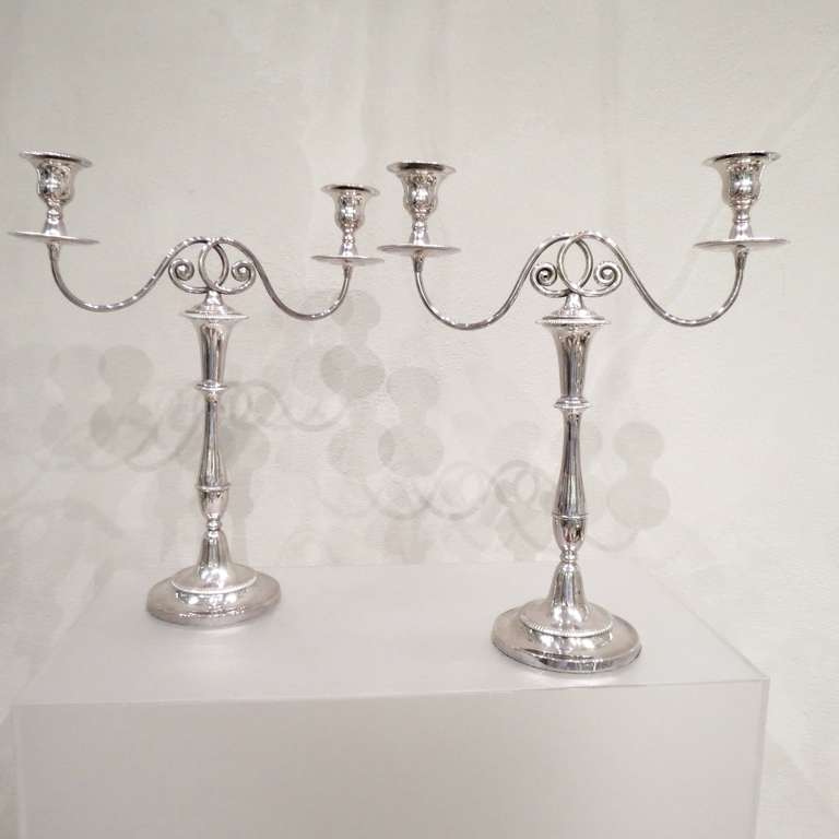 An elegant pair of antique candelabra in Old Sheffield plate with detachable arms and sconces. Very pleasing plain classical style with restrained decorative features, circa 1790. Measures: Height 42 cms, 29 cms (candlestick only). Spread 34.5 cms.