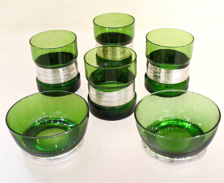 A set of four green glass silver mounted (9.5 cm height, 8cm diameter) and two nut bowls (cm 5.5 height, 11cm diameter).