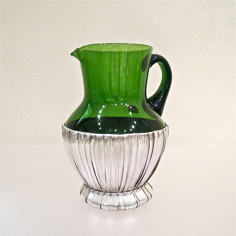 This green glass pitcher is enclosed in a sterling silver straw basket reproducing the typical Italian chianti wine 