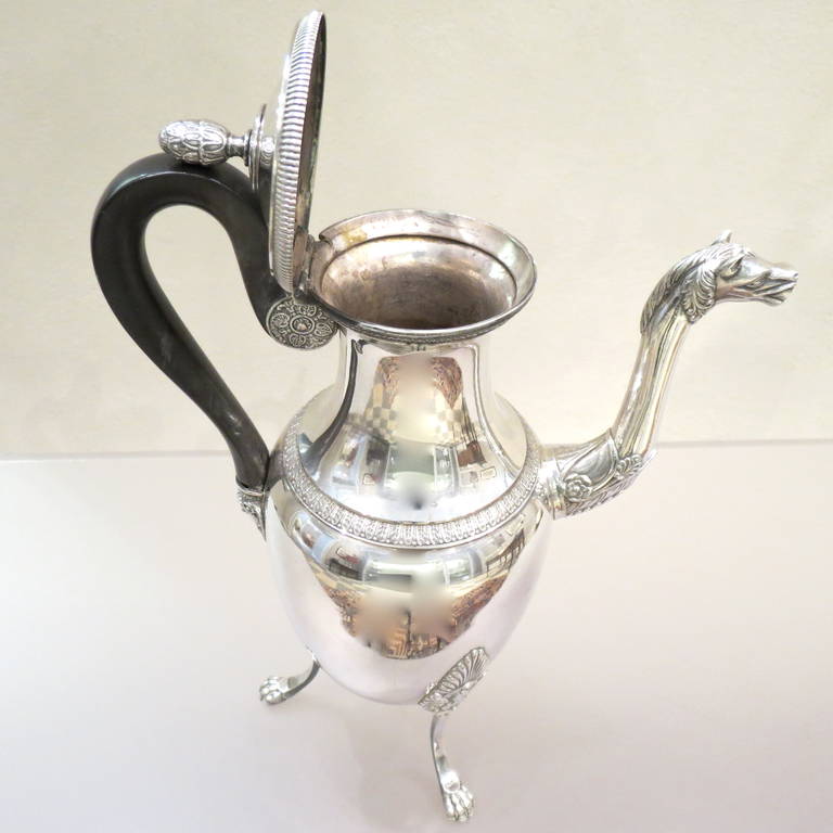 A very good quality French Empire Egyptian taste 950/°°° silver coffee pot, Paris 1819. Oviform body supported on three claw feet ornamented with horse sphinx motifs, ebony handle and horse head spout. Fully hallmarked. 
Height 30 cm.
Weight 848