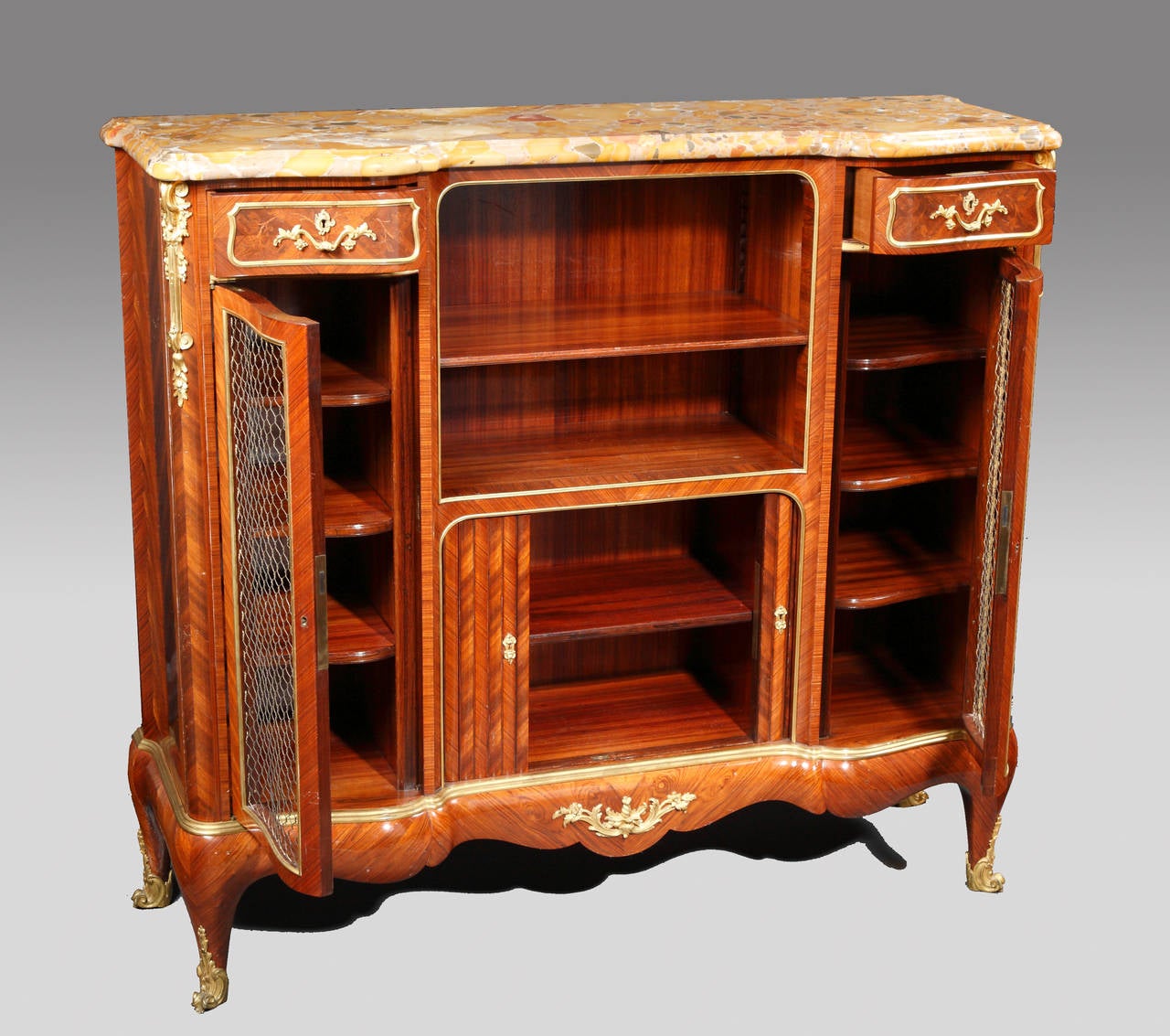 Stamped Sormani à Paris and signed on the lockplates P. Sormani, 10 rue Charlot, Paris.

Rare pair of Louis XV style side bookcase-cabinets of exceptional quality made in kingwood and tulipwood veneer, topped with moulded and serpentine shaped