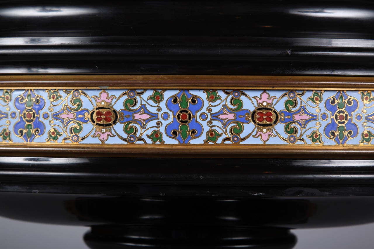 A oval fine black marble Jardiniere mounted with polychrome 