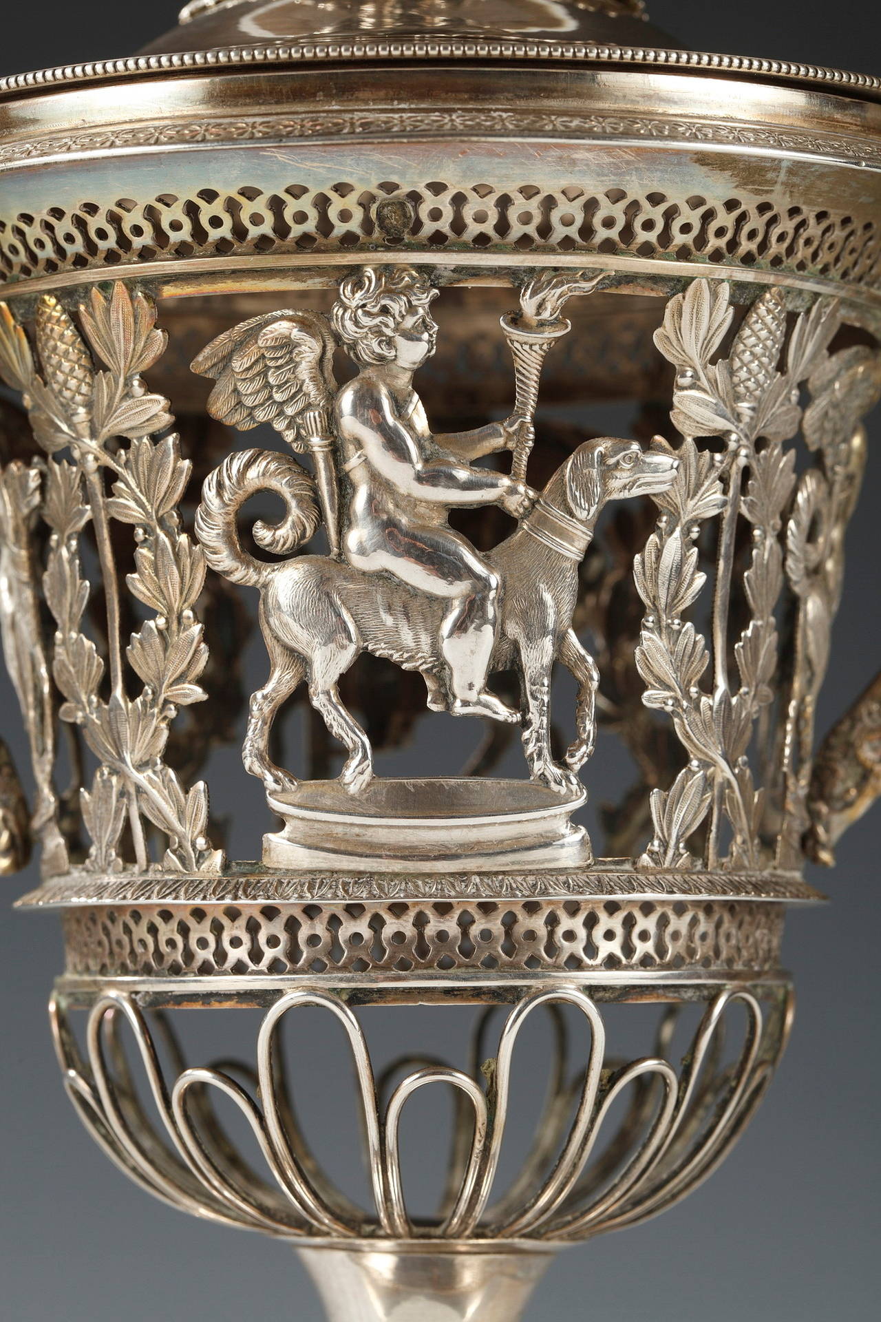 Solid silver sugar bowl and cover figuring a delicate decor of cherubs riding dogs separated by foliage rolled up around a sceptre top by a pine cone.
Model by Dennis Garreau (Hallmarked DG) 
Vieillard Hallmark