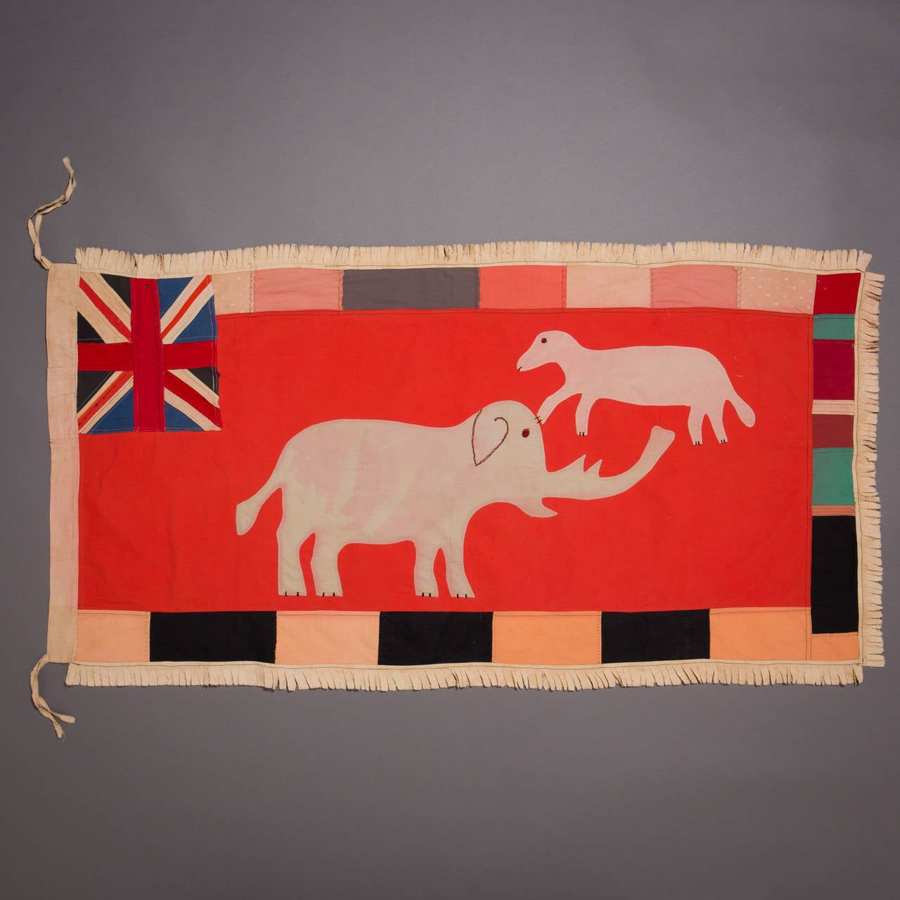A large and graphically stunning asafo flag.

Fante flags represent the merger of two cultural traditions, the Akan tradition of combining proverbs with visual imagery, and the European heraldic tradition, which used flags and banners displaying