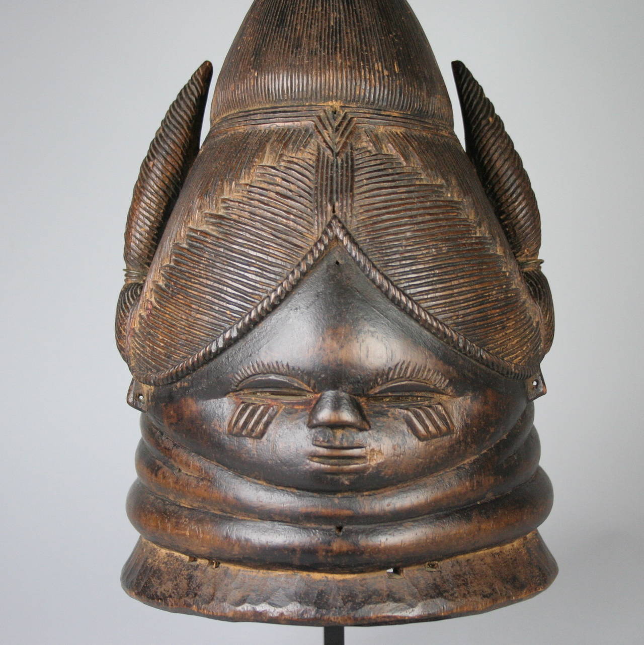Beautiful and historically fascinating, this tribal Mende mask will make the perfect addition to any collection or home decor scheme. Crafted to represent the idealized woman, it would have been used in initiation ceremonies for young girls entering