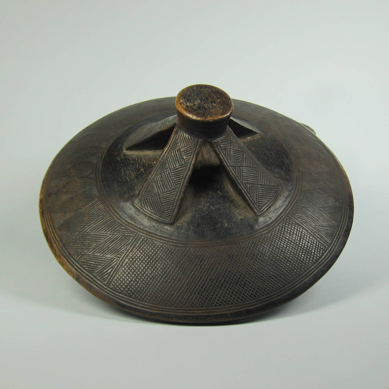 An extremely fine wood Lozi lidded vessel, Zambia, circa 1930s.

At the turn of the 20th century, vessels decorated with zoomorphic or geometric handles became the decorative art form in Western collections that epitomized Lozi culture. 

The