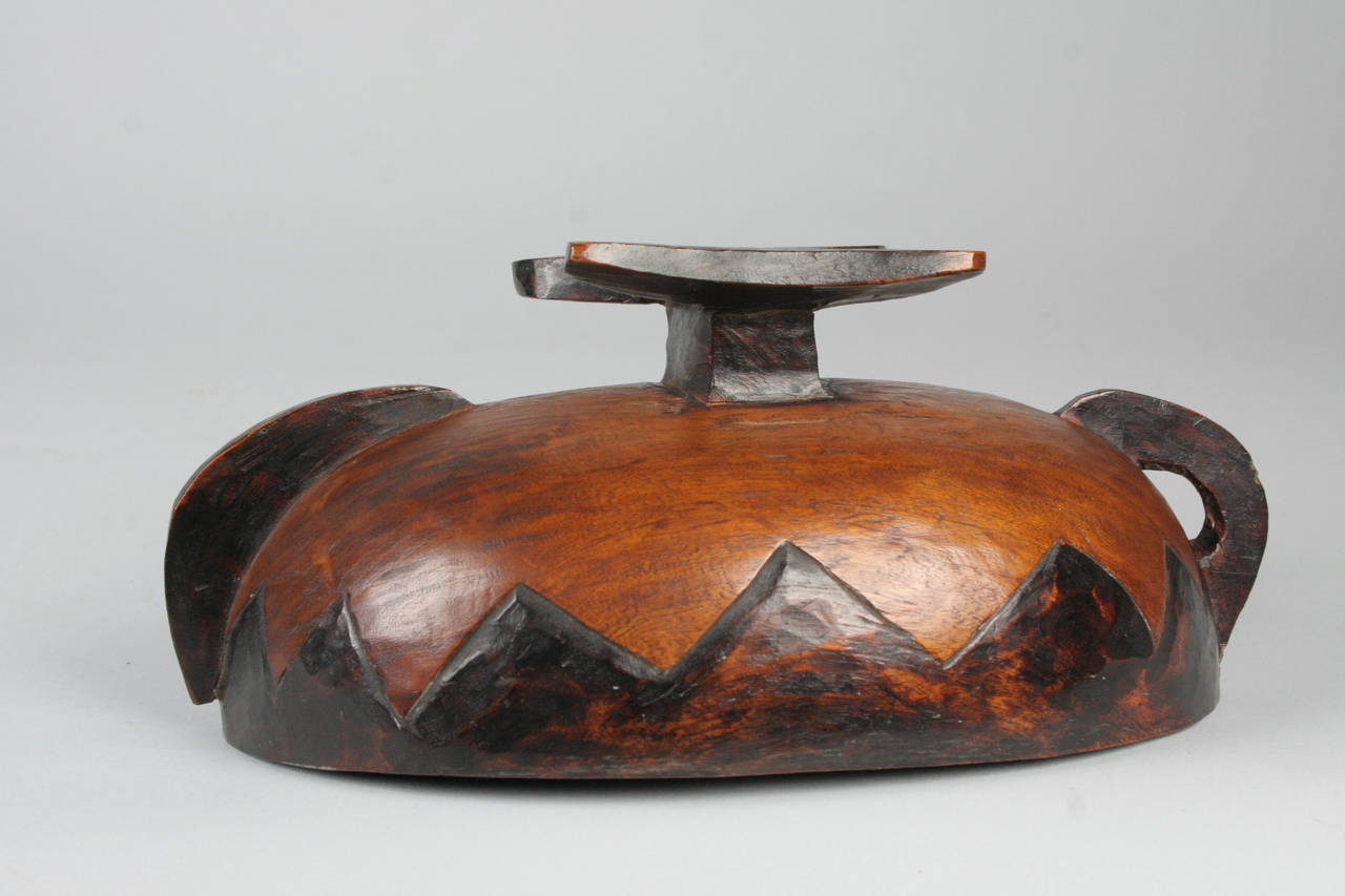 This small wooden Sotho prestige vessel boasts a carved geometric design and a beautiful smooth finish. The blackened design was produced by using a hot poker. 

Perfect for display or decorative use, it would have been a symbol of status at the
