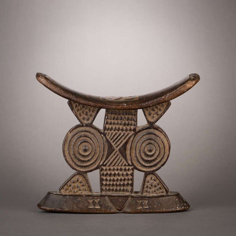This is a magnificent example of the classic tradition of headrest carving in Southern Africa. Created as both practical objects of daily use to protect elaborate hairstyles and conduits of ancestral wisdom, these works ranged from the Minimalist to