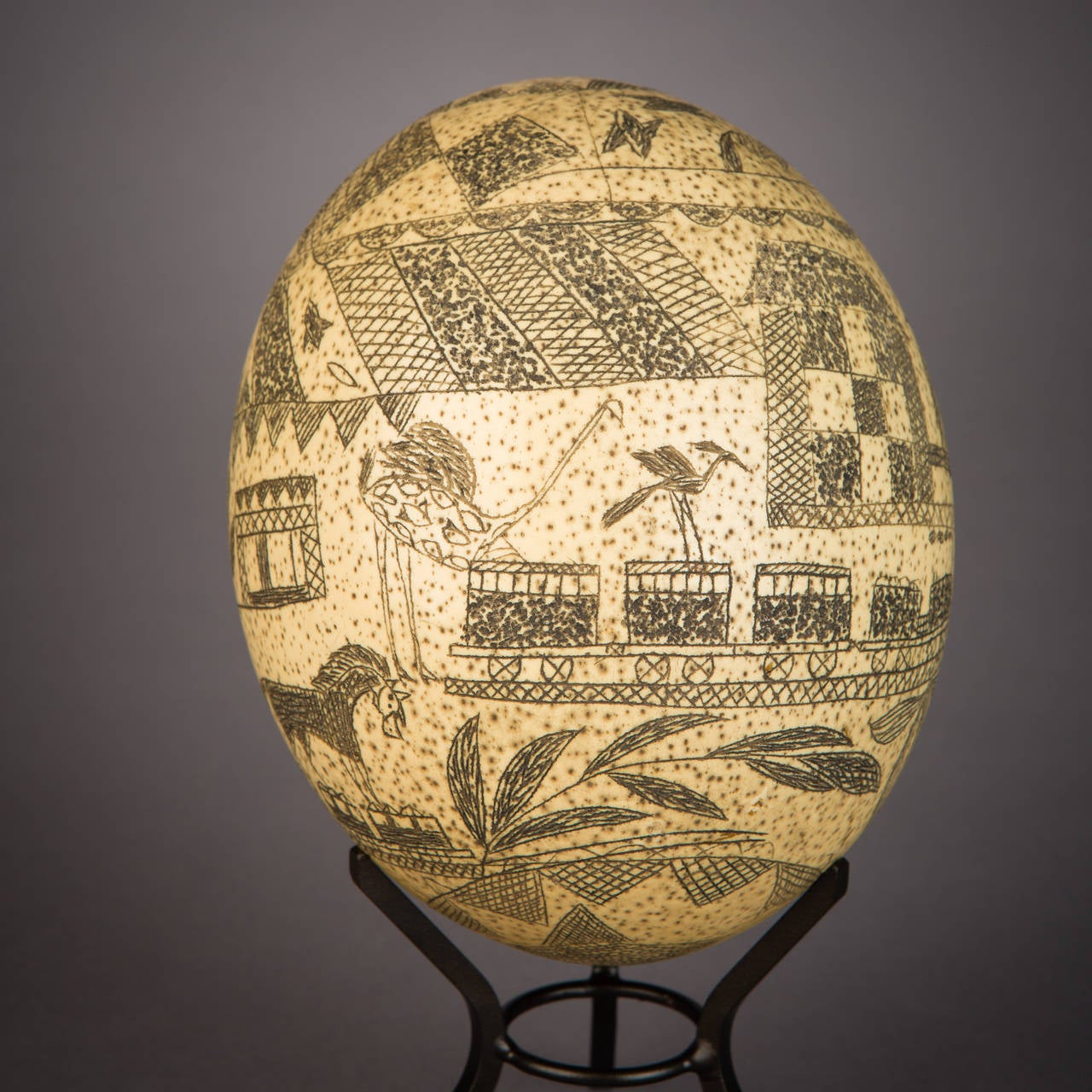 Ostrich eggs adorned with incised images are an ancient form of art in Africa's southern reaches, though few examples display the particular character and content found here. This example was likely carved by a South San carver working in the Cape