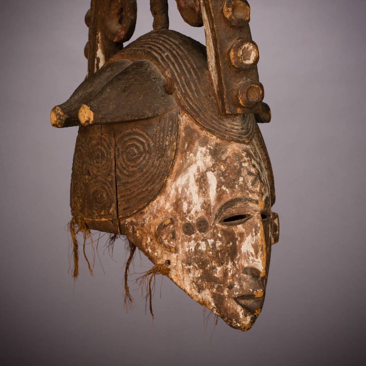 Igbo maiden masks represent cultural ideals of femininity, both physical and moral and are primarily danced during agricultural festivals and certain funeral ceremonies of prominent individuals. Like others of its type, this example features a