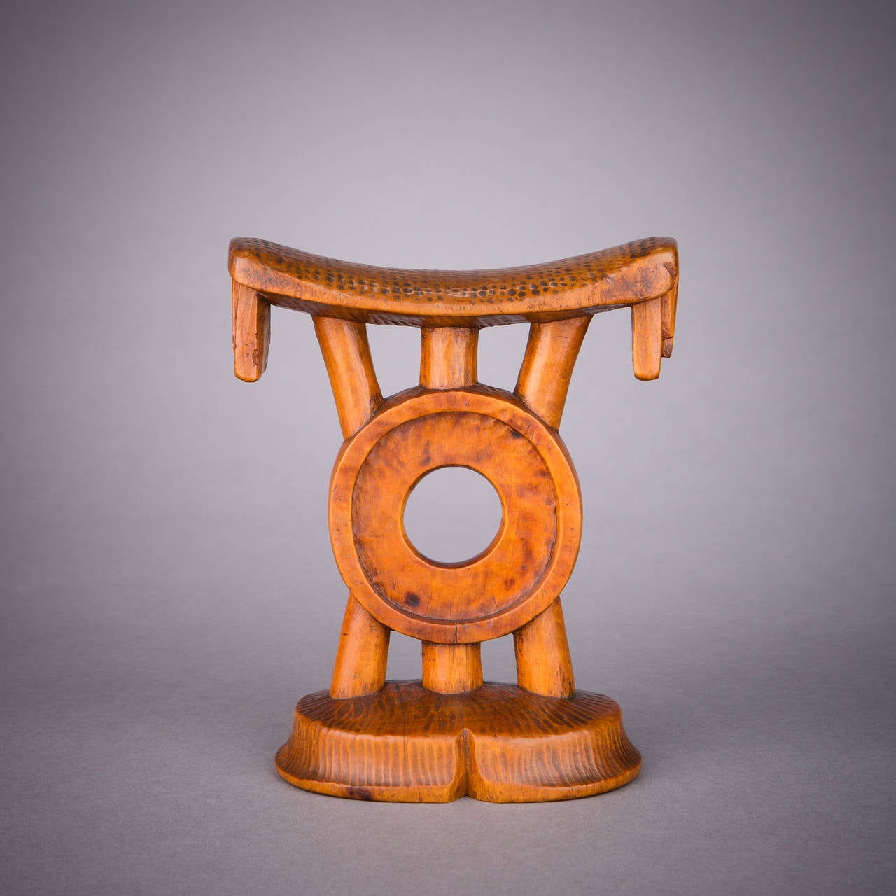 A lovely and compositionally unusual Tsonga headrest with a striking central ring motif. Tsonga carvers were often creative, playful and ingenious in their approach to the architecture of their headrests, a tendency wonderfully illustrated here.