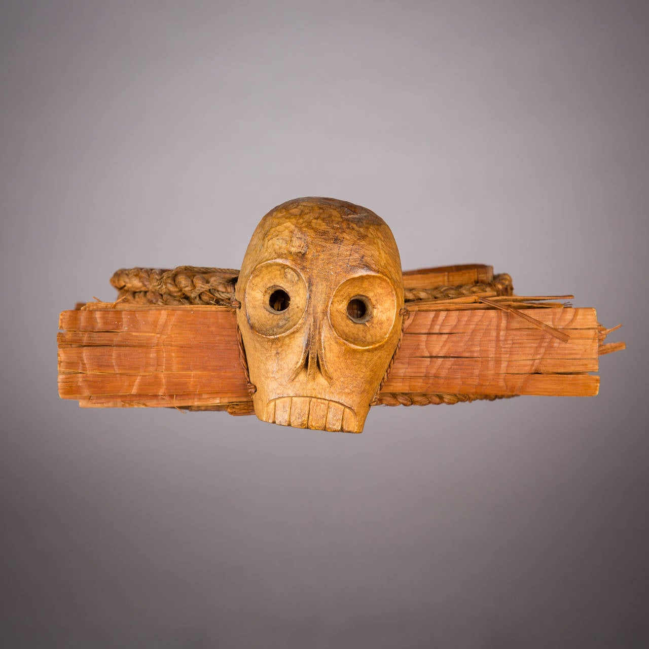 This fine and rare, headdress with skull motif, is of a type used in the initiatory Hamat'sa (Cannibal Dance) ceremony and forms an element in its associated regalia. One of the most important of Kwakiutl winter rituals, the Hamat'sa sees the