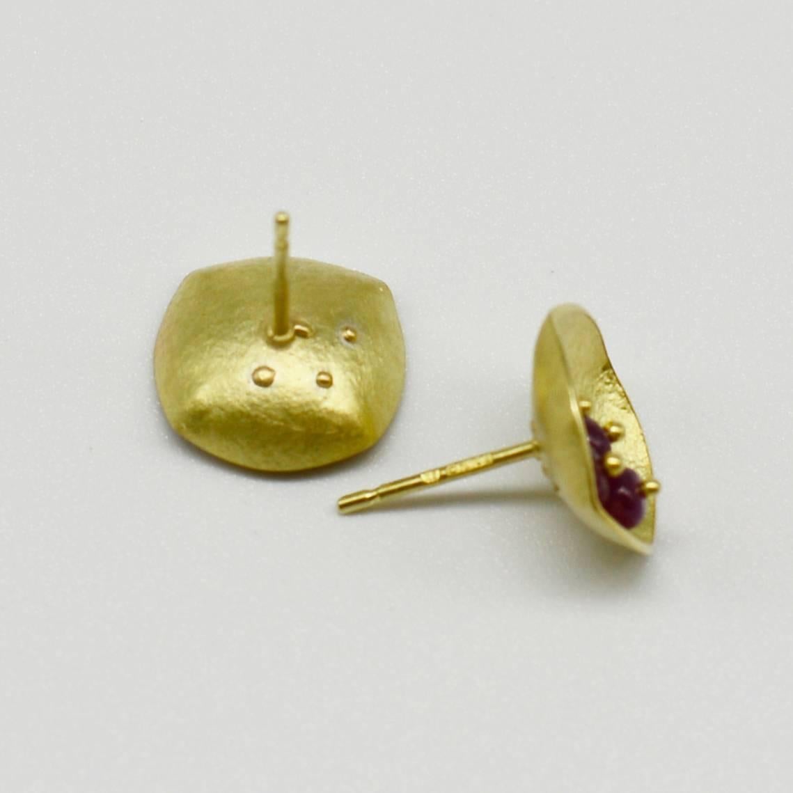 Berry-like ruby beads are placed in a simple square shape made of gold sheet. These beads are attached with a fusing technique, using a spot welding machine whose pinpoint accuracy protects the stones from heat damage.   

Lead time up to 4 weeks 