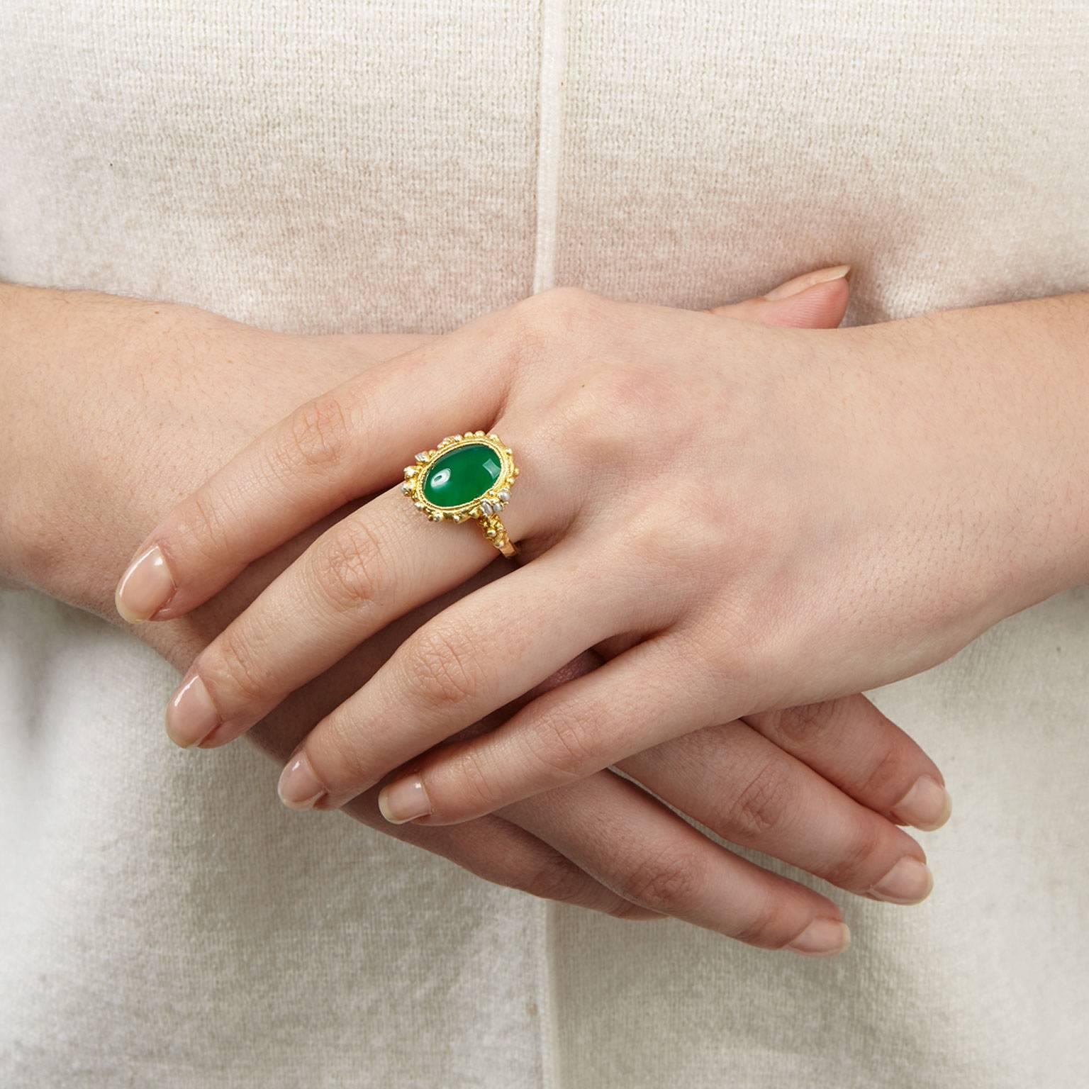 Be the envy of all your friends with the vivid Mayflower ring.
A forest-green agate stone sits at the centre, encrusted in golden granules and a scattering of seed pearls atop a hammered band. All in gold plated silver.
Bringing a touch of opulence