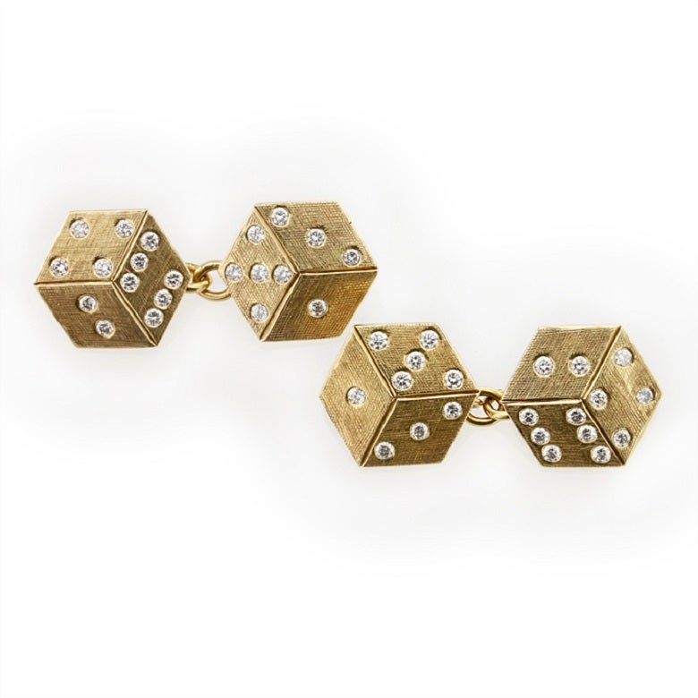 A pair of 1950s Cartier dice cufflinks, each link comprising two three-dimensional cross-etched yellow gold dice, set with round brilliant-cut diamonds, estimated to weigh a total of 0.55 carats, with chain link connections, signed Cartier, gross