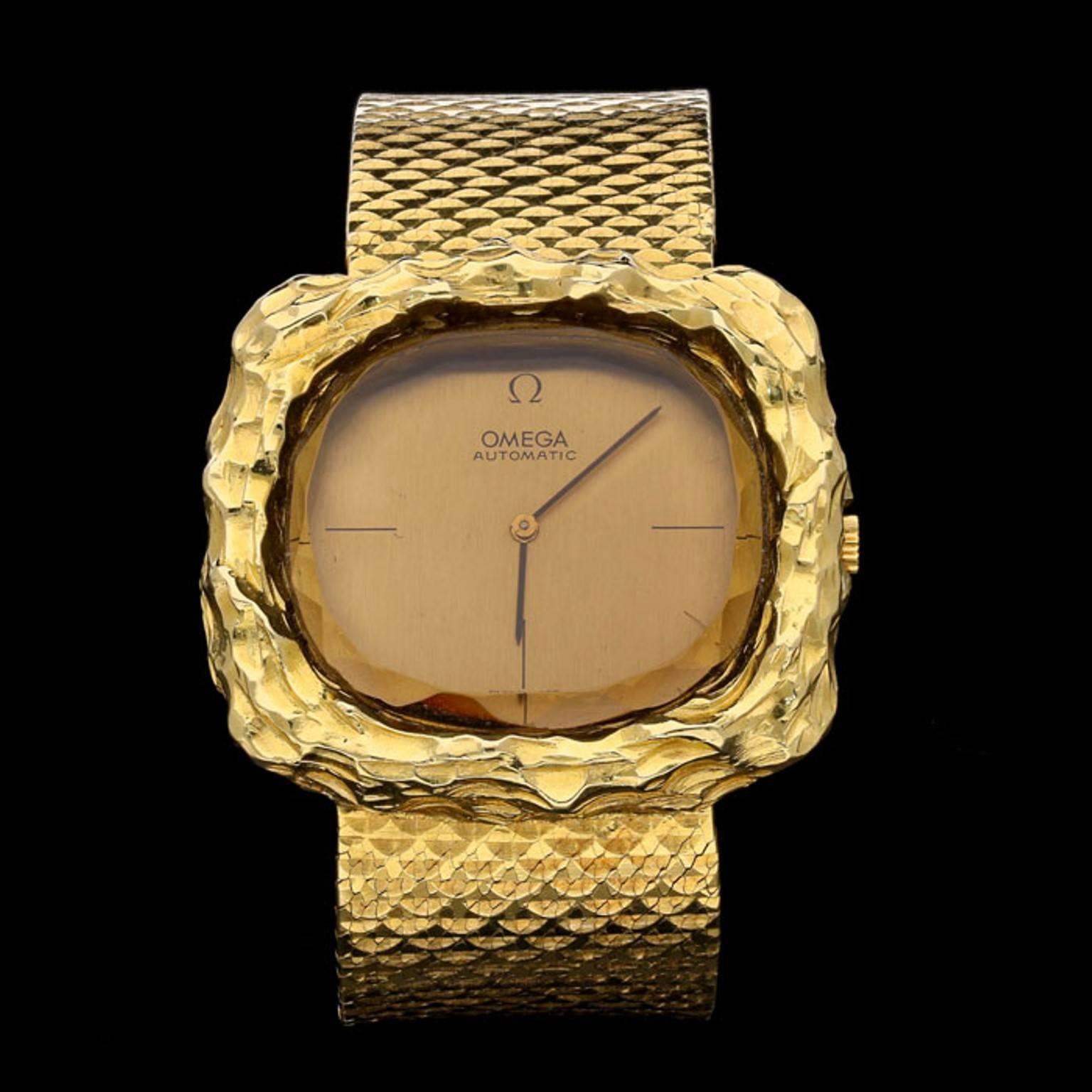 A yellow gold ladies 'Teak' automatic watch by Andrew Grima for Omega, c.1970, the wide straight strap finely crafted in textured 18ct yellow gold with a cushion-shaped face with yellow gold dial featuring black baton hour and minute hands and