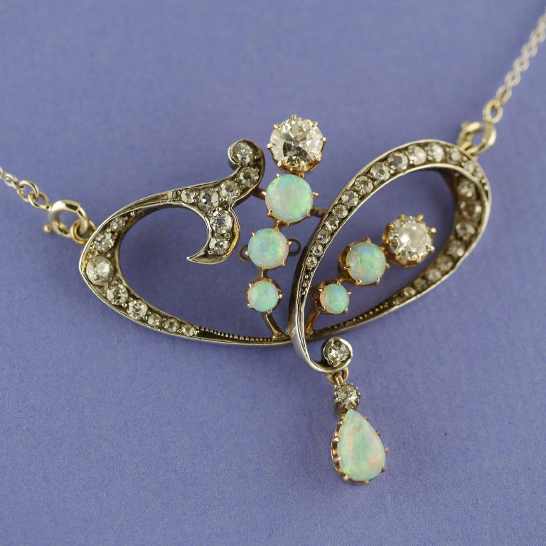 18ct gold & silver set Art Nouveau  Diamond Opal Pendant/Brooch dated  circa 1900

Five round opals with an articulated pear shaped opal drop, very well matched with lively play of colours and iridescence in reds, greens, blues and gold. Set in 18