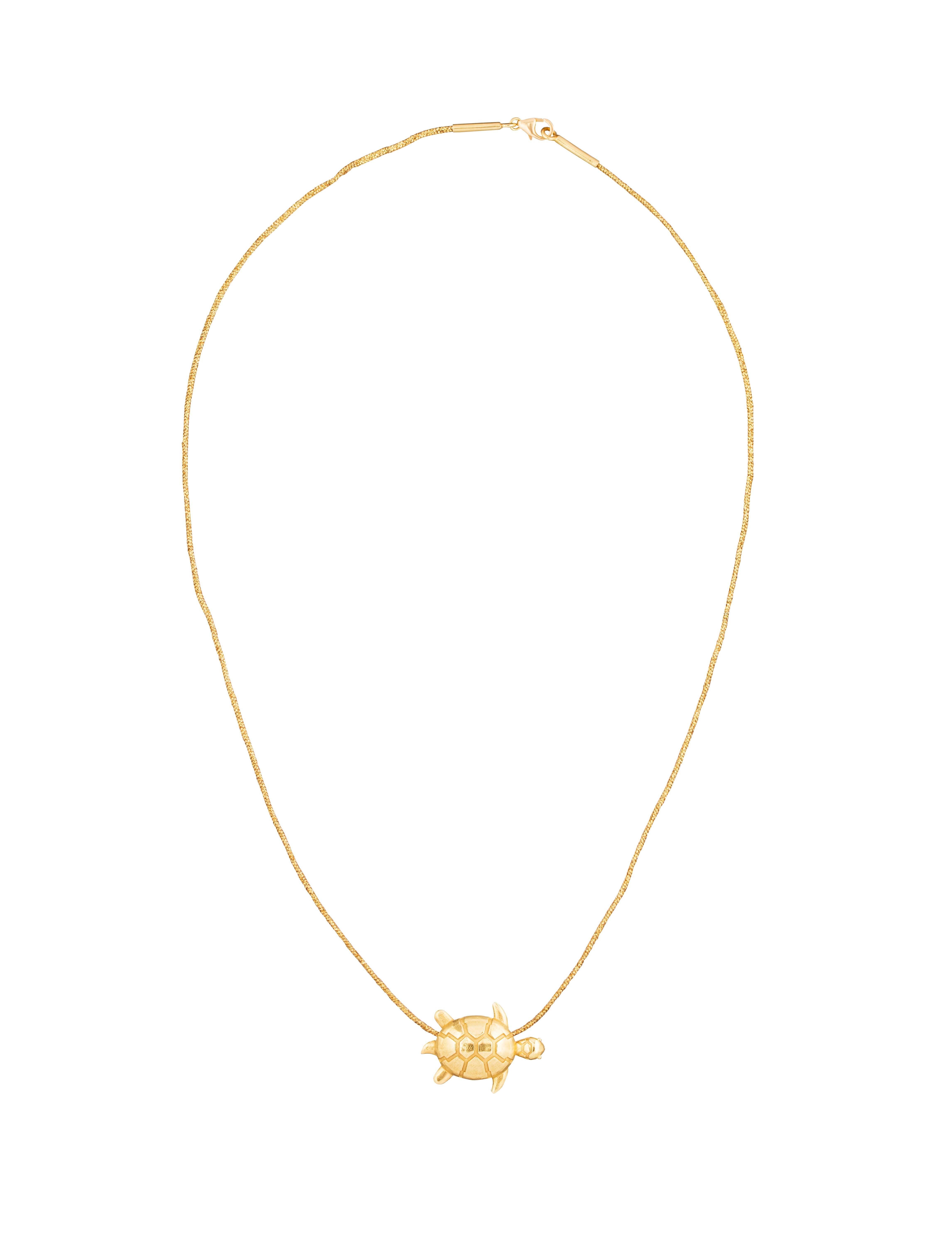 18 Karat Gold Turtle Necklace On Cotton Cord With 18 Karat Gold Clasp. 

The Turtle Is a Symbol Of Prosperity, Growth and Good Luck In Asia and Around The World. I Wear Mine Every Day As a Talisman of Positivity and Luck. There is a Lovely