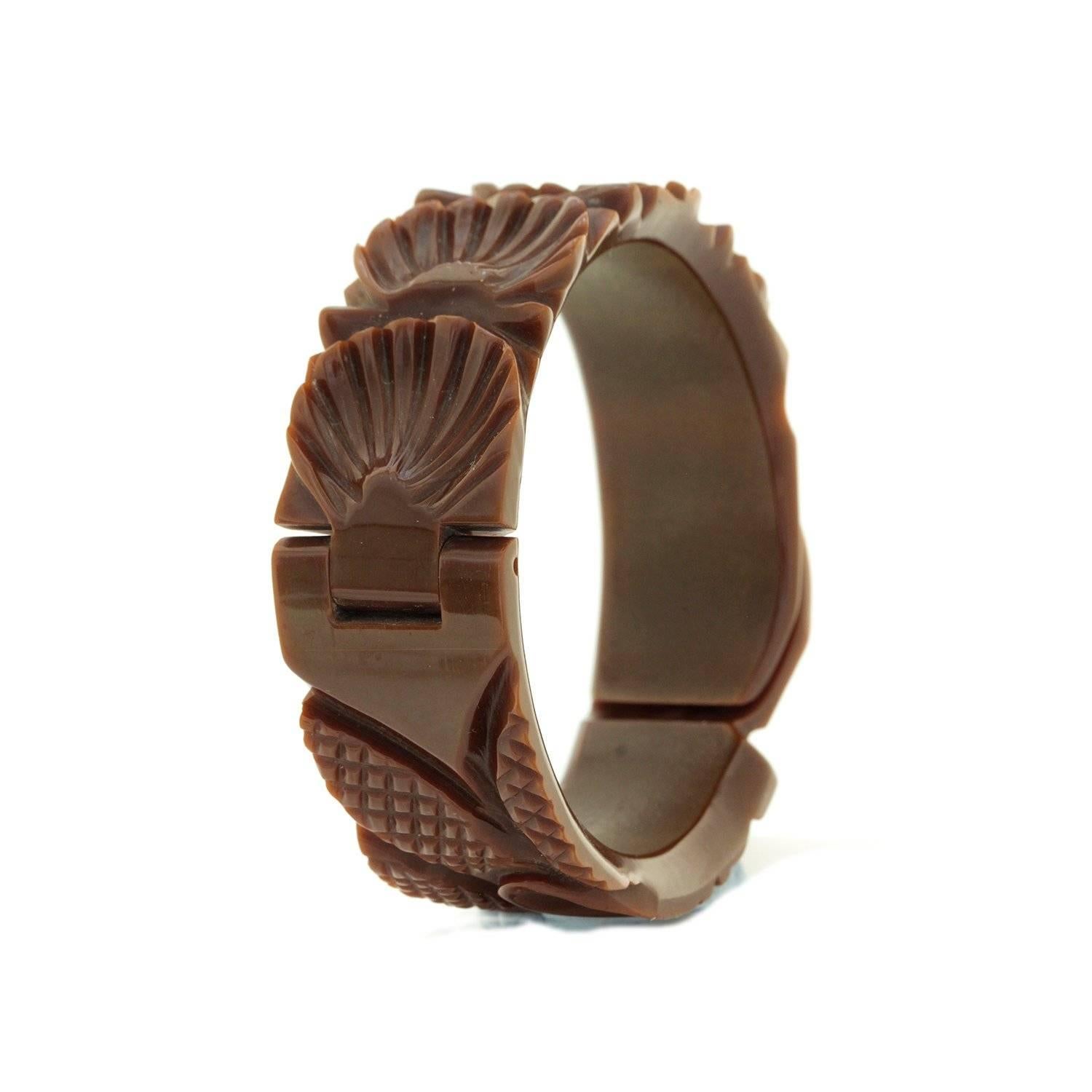 Vintage Art Deco Hand Carved Milk Chocolate Coloured Bakelite Bangle

Gorgeous Art Deco era Hand Carved Bakelite Bangle with Bakelite hinge and clasp in a rich Milk Chocolate colour. Bangle features Leaf, petal and pineapple patterns. A fabulous