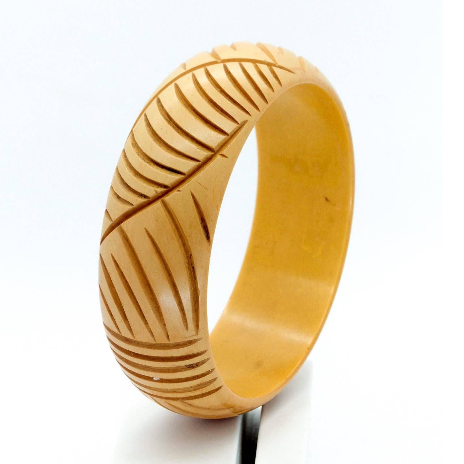 Art Deco light Butterscotch Bakelite Bangle, featuring leaf- like patterns.  We are happy to give this a polish to bring up the shine for the buyer however we leave the matt finish as is until sold as most collectors like to see a vintage piece in
