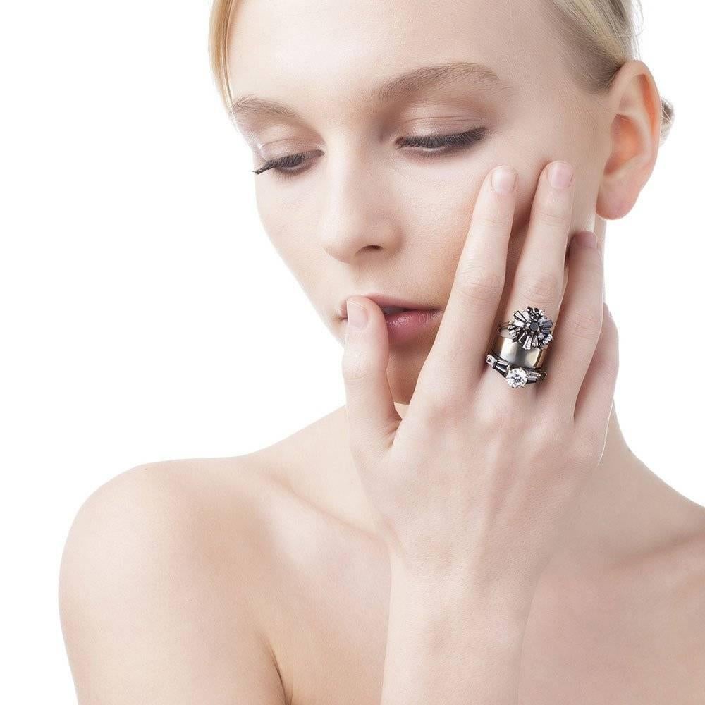 Three single rings stacked together to make one, this cocktail ring features an optical mix of black and white crystals set by hand. Loaded with unexpected charm, the stacked ring exudes Iosselliani's love for shimmering crystals. Designed in Italy