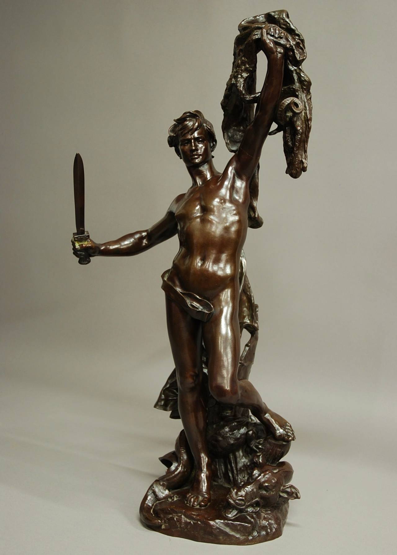 A large bronze of 'Jason and the Golden Fleece' by Alfred Desire Lanson (1851-1898).

This bronze has a rich dark brown patination and is in excellent condition dating around 1895.

The figure is portrayed with a sword in his right hand, holding