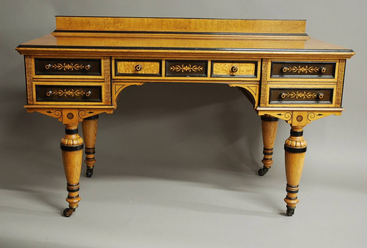 An unusual Victorian Hungarian ash and inlaid boxwood and ebony side or writing table of Fine quality.

This piece consists of a Fine figured top veneered in Hungarian ash with a part ebonized moulding.

The table also has a moulded back rail,