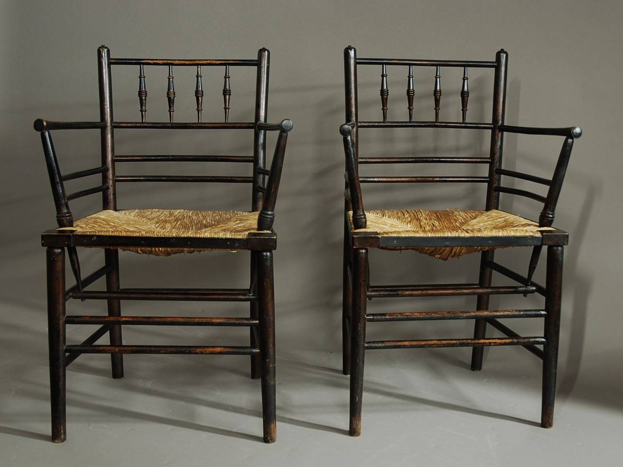 A set of six Morris & Co. Sussex chairs designed by Phillip Webb, comprising of two carvers and four single chairs all in good, original condition purchased from a private collection.

The chairs consist of four turned spindles on the back rail