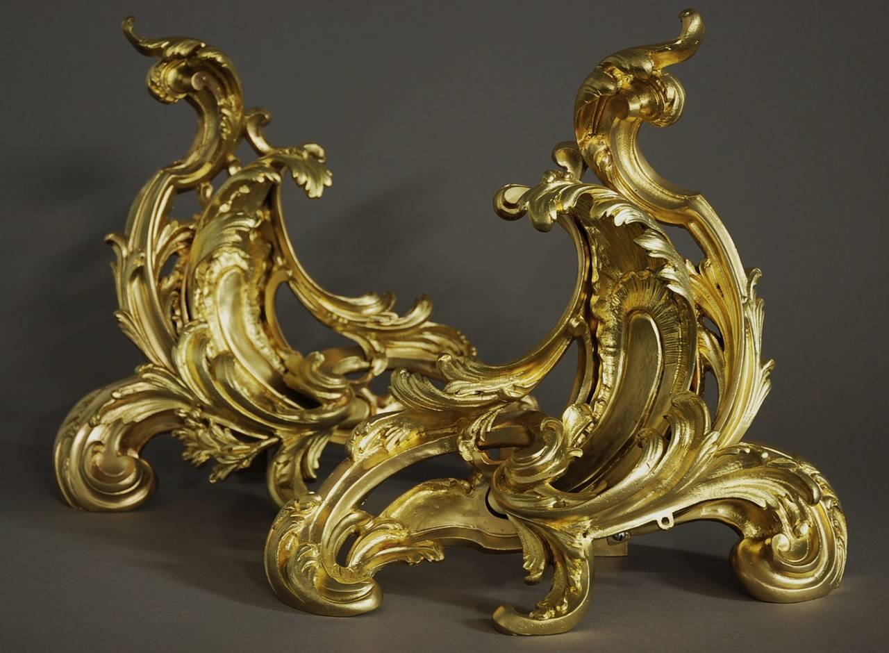 A pair of late 19th century ormolu (gilt metal) chenets in the Rococo style.

These chenets or fire dogs are in the typical Rococo design of scrolling foliage and acanthus.

These items are in very good condition and have recently been