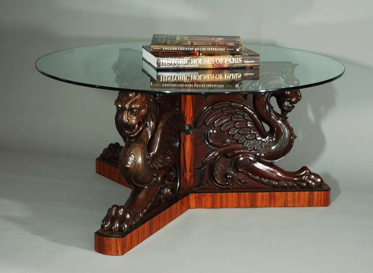 A late 19th century superb tri-form base coffee table with circular glass top. This is a highly decorative piece of excellent quality. <br />
<br />
This table consists of a base with three finely carved chimera (a mythological creature commonly