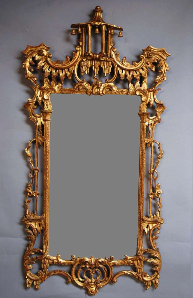 A fine quality early 20th c Chinese Chippendale style gilt wood and carved mirror.

This mirror has typical Chinese Chippendale influences consisting of a Pagoda to the top with four supporting columns.

These lead down to an extremely