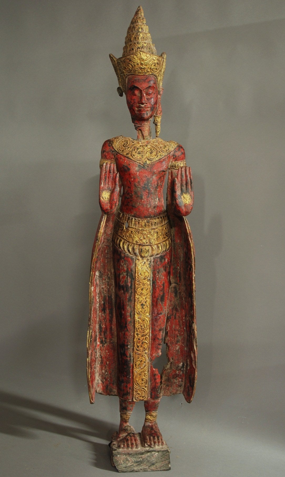 A highly decorative large early 20th century South Asian polychrome carved wooden figure of a Buddha, possibly Burmese.

The figure depicts a South Asian Buddha standing with arms outstretched and has a weathered appearance.

The carved wooden