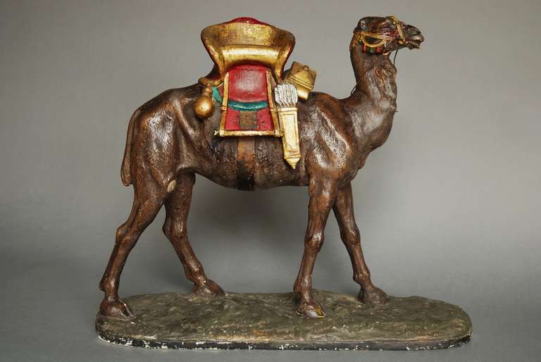 A highly decorative late 19th century-early 20th century painted plaster camel in the Bergman style.

This is very similar to the bronzes by Bergman but this is in plaster, not bronze but still has a very decorative look. 

There is some ware to