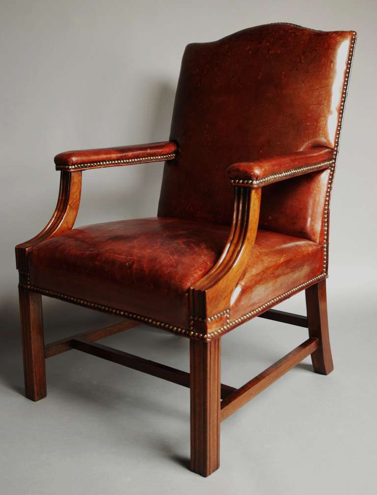 A good example of a mid 20th century reddish/brown leather Gainsborough chair, the leather having a worn appearance.

The chair has a mahogany frame and is in stable condition and can go straight into a home.