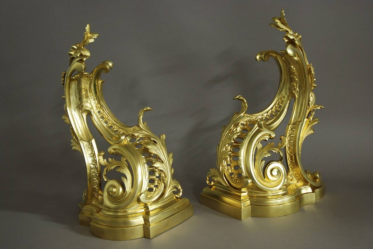 A pair of French Rococo style ormolu chenets/fire dogs of fine quality.

These chenets are of typical Rococo design of scroll shape with scrolling foliage and acanthus leaves.

They are of very fine quality and in excellent condition and have