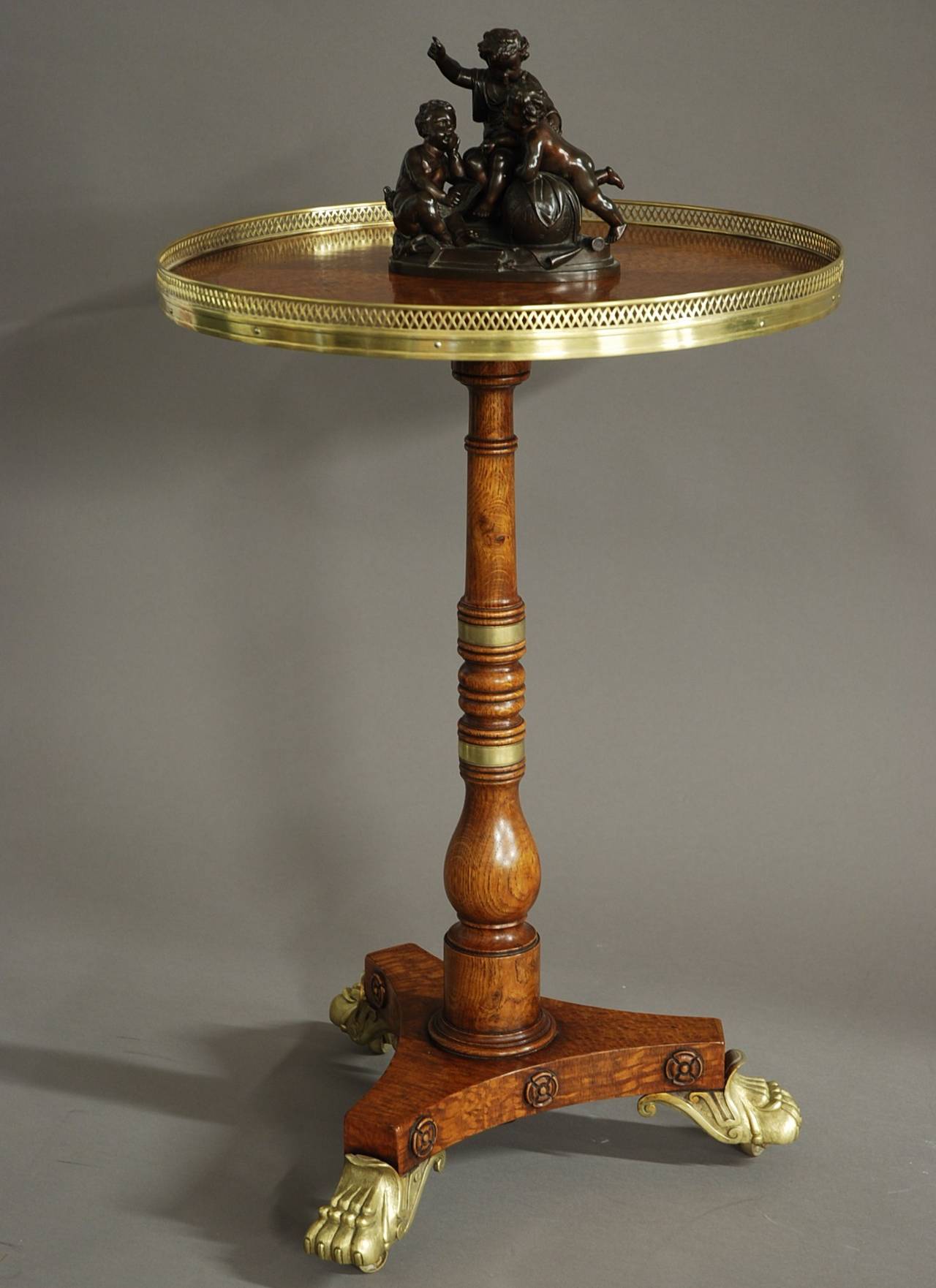 An early 19th century oak occasional table of fine quality.

This table consists of a burr yew wood panel to the center surrounded by a well figured oak segmented circular top with oak crossbanding. 

This leads down to a turned oak column with