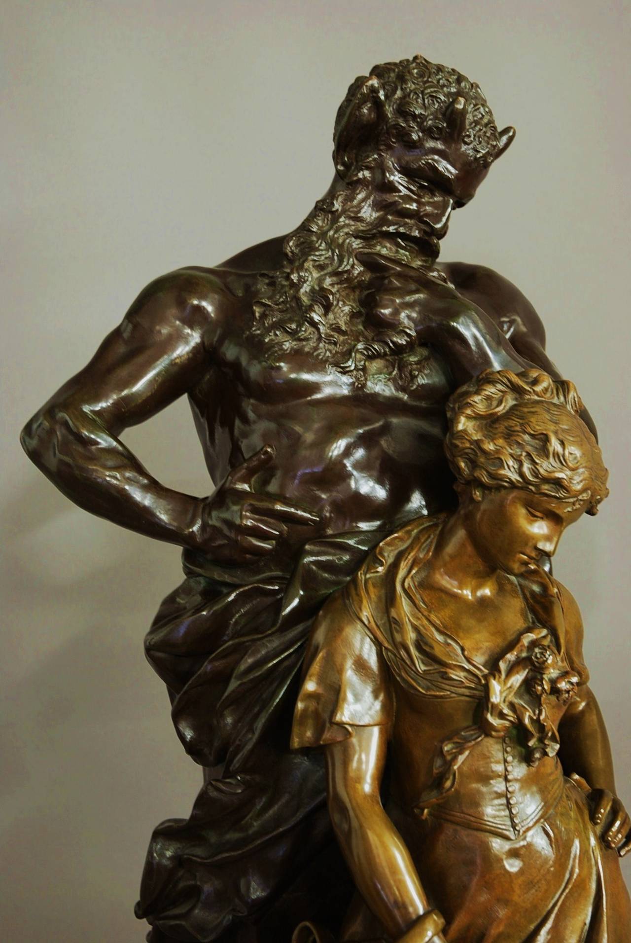 A French superb quality late 19th century large bronze of Pan with a young maiden, circa 1895 by Luca Madrassi (1848-1919) of fine patination.

This bronze consists a young maiden holding a water carrier with Pan depicted behind her staring